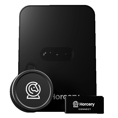 A sleek, black Horcery Stall Monitor, accompanied by a Bucket Meter and a Horcery Connect device, all featuring the Horcery logo. The design emphasizes modern, tech-forward equine monitoring hardware.