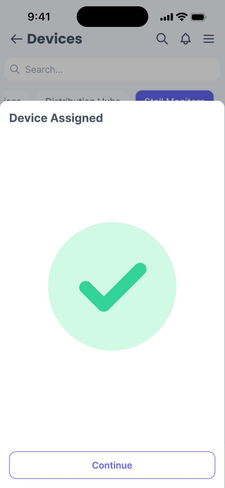 Phone screen with a large green tick mark, titled 'Device Assigned'.